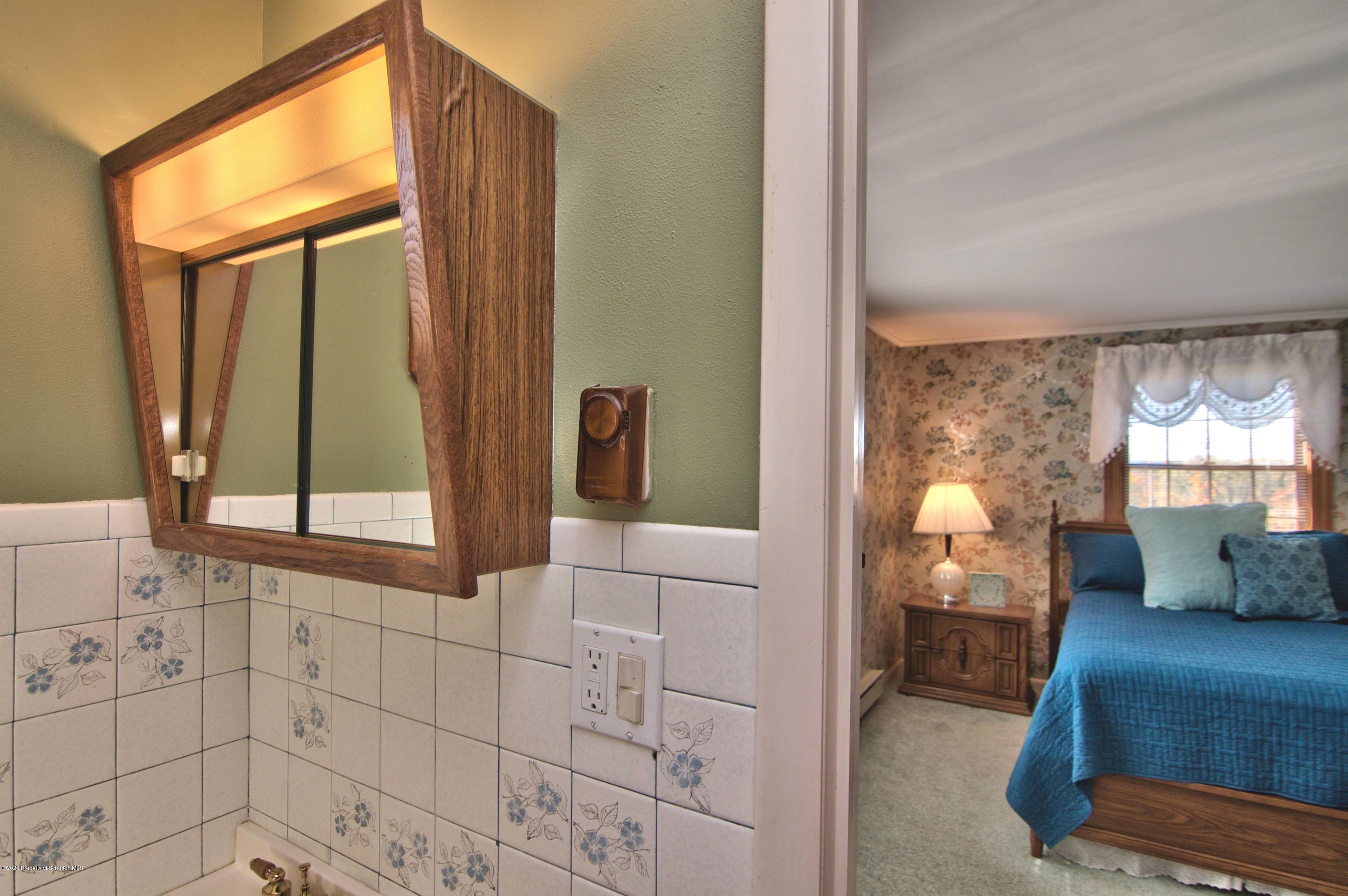2151 Aberdeen Road Moscow, PA 18444 - Photo 29 of 65 a view of a bathroom with a window and mirror