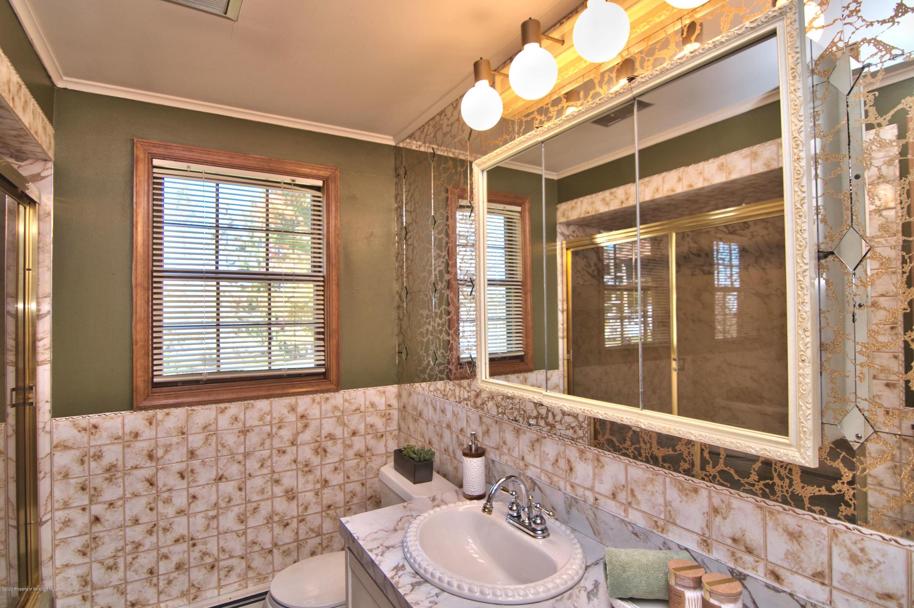 2151 Aberdeen Road Moscow, PA 18444 - Photo 34 of 65 a bathroom with a sink and a mirror