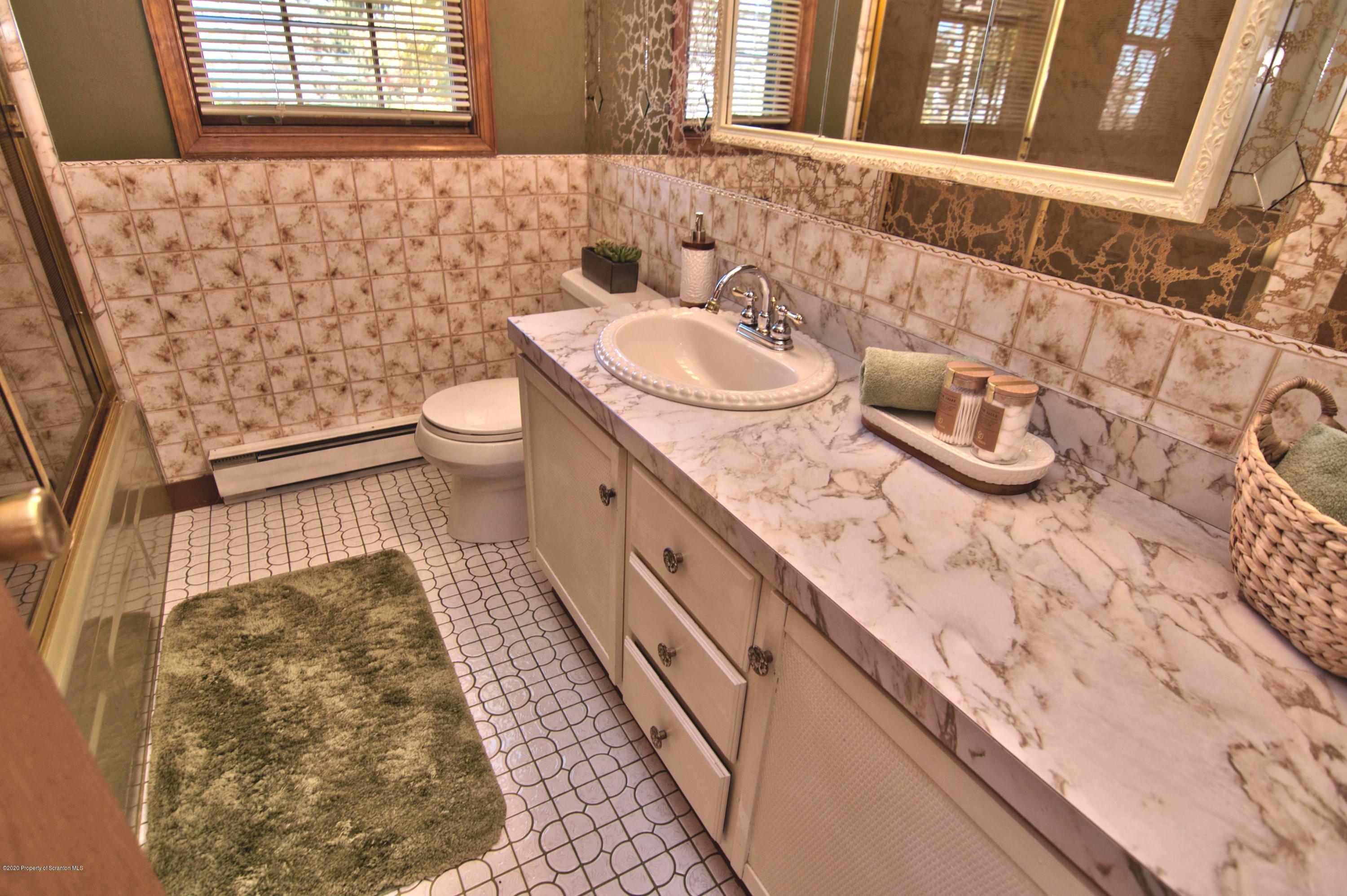 2151 Aberdeen Road Moscow, PA 18444 - Photo 35 of 65 a bathroom with a granite countertop sink and a toilet