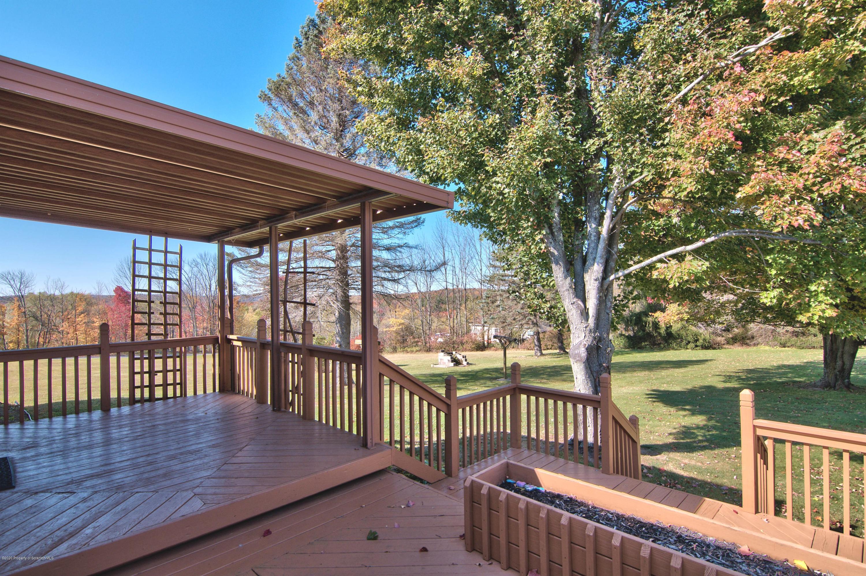 2151 Aberdeen Road Moscow, PA 18444 - Photo 49 of 65 a view of a wooden deck with a bench