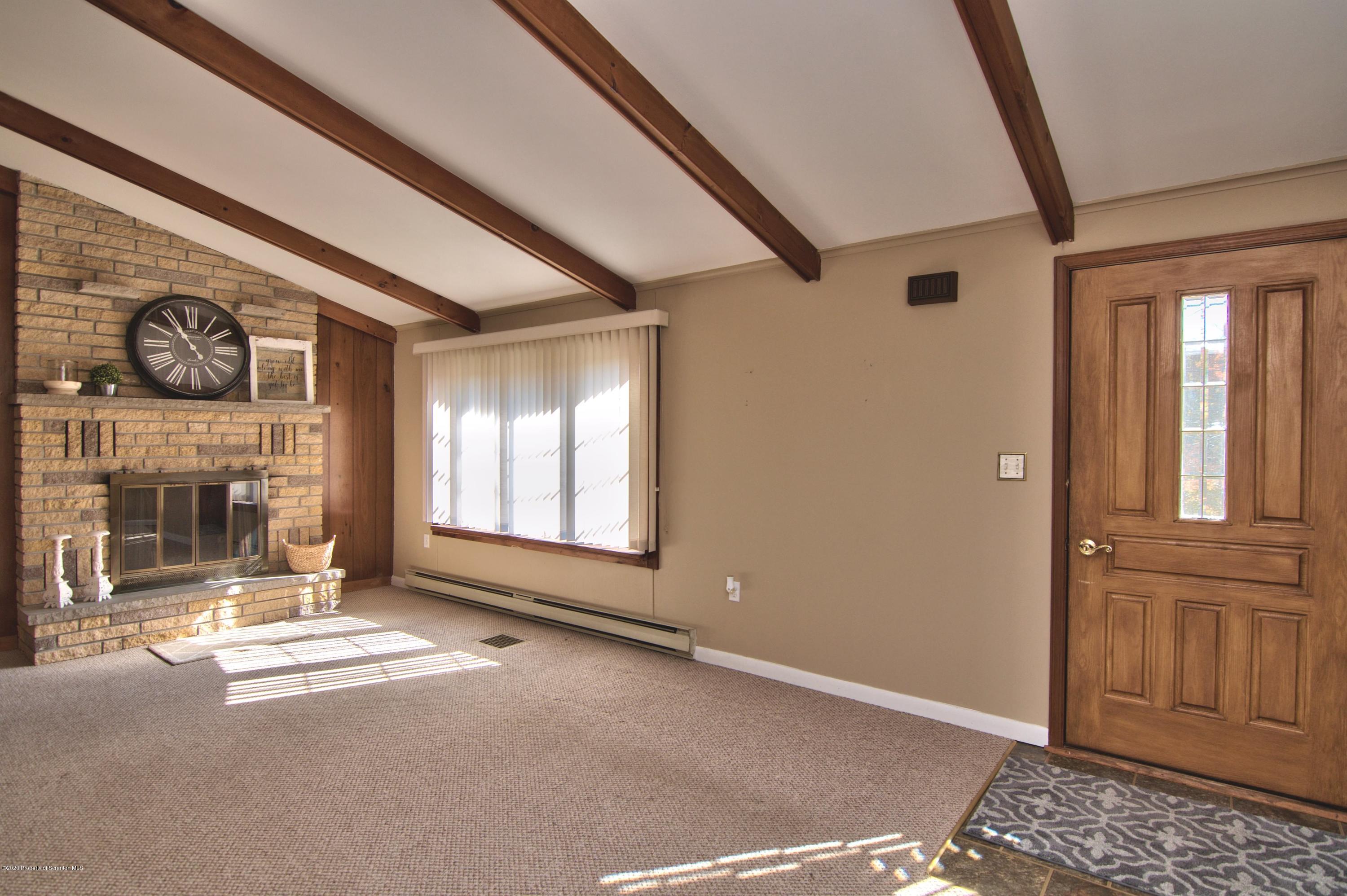 2151 Aberdeen Road Moscow, PA 18444 - Photo 5 of 65 a view of an empty room with a fireplace and a window