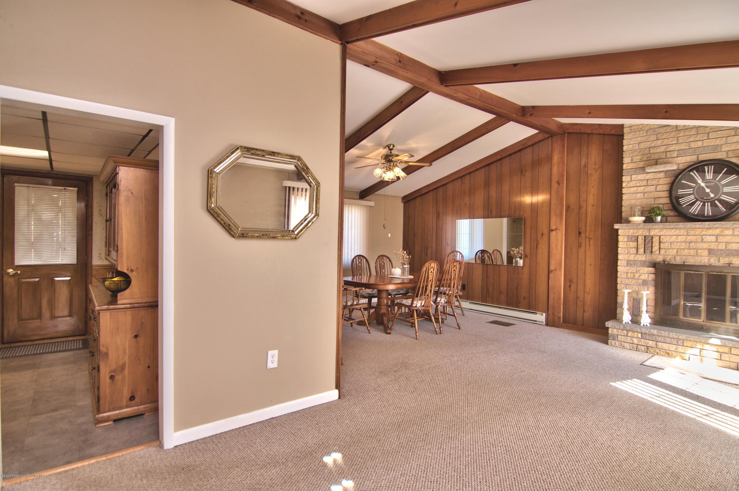 2151 Aberdeen Road Moscow, PA 18444 - Photo 6 of 65 a view of a hallway with dining area and chandelier