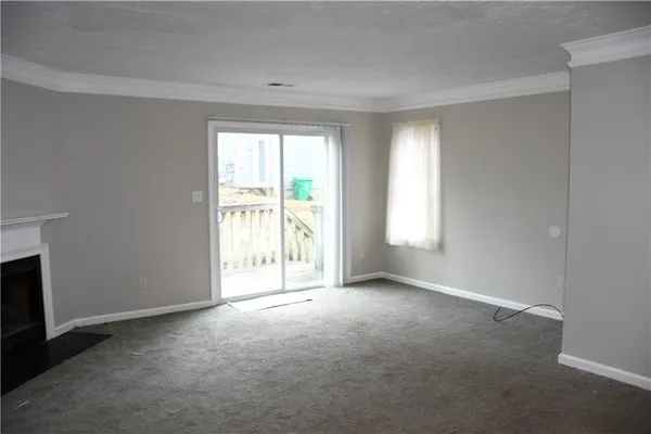 a view of an empty room with a fireplace