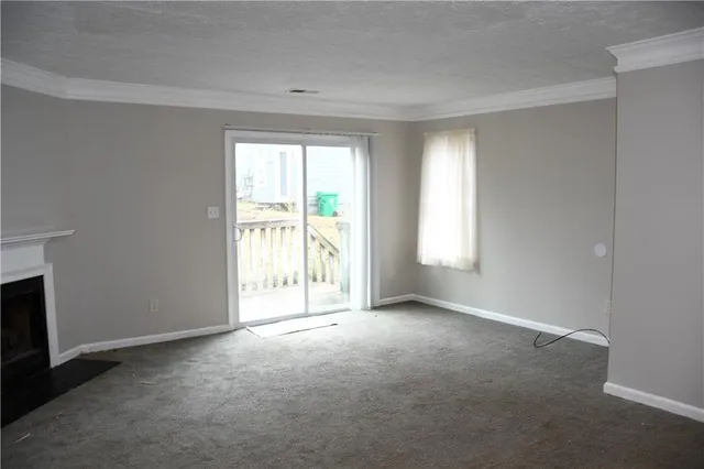 a view of an empty room with a fireplace