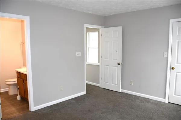a view of an empty room with a closet