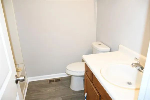 a white toilet sitting next to a white sink