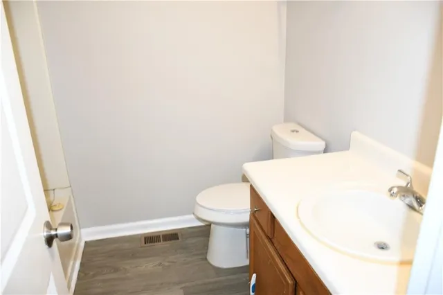 a white toilet sitting next to a white sink