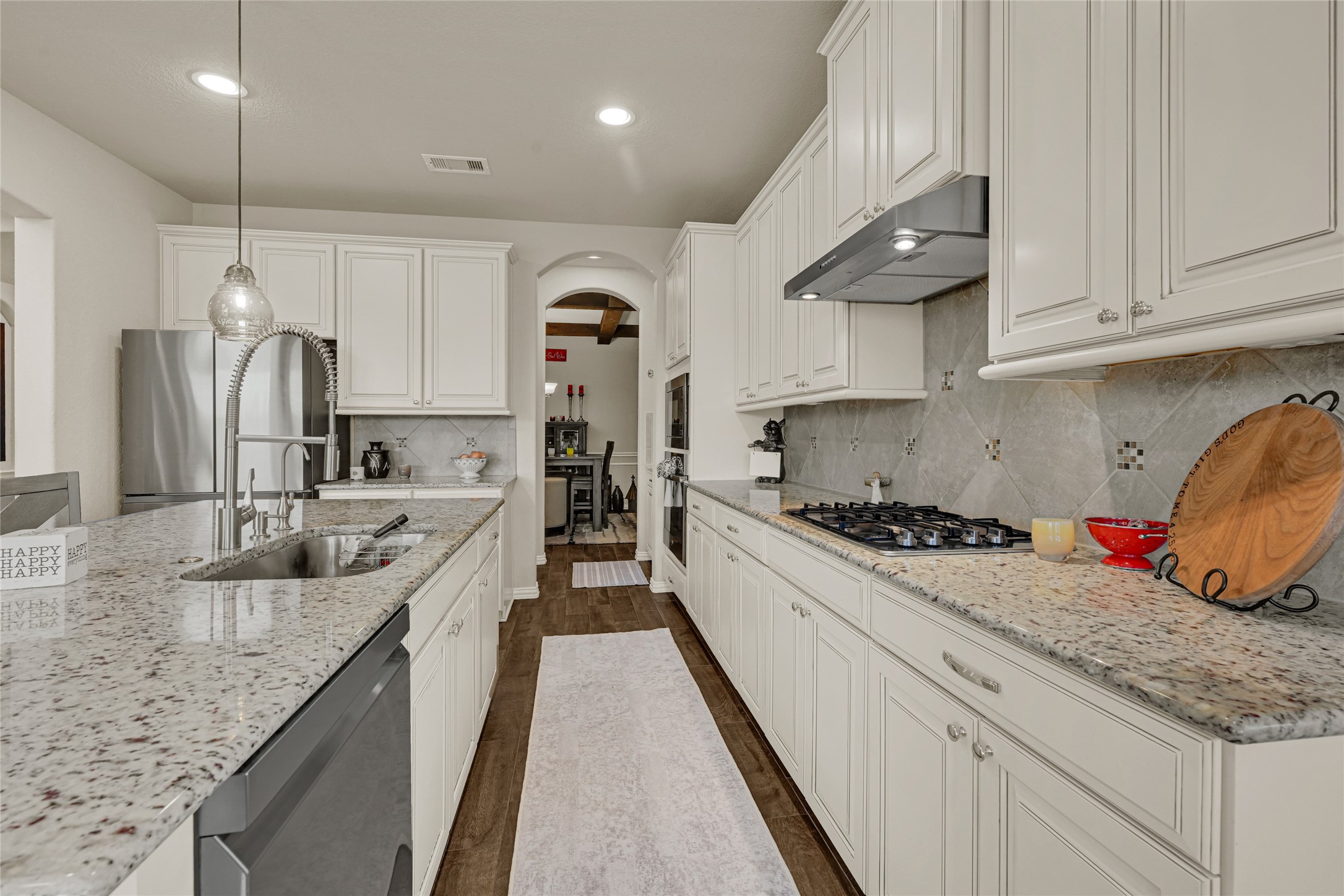 10319 Silver Shield Way Tomball, TX 77375 - Photo 12 of 46 a kitchen with stainless steel appliances granite countertop a sink a stove and a refrigerator