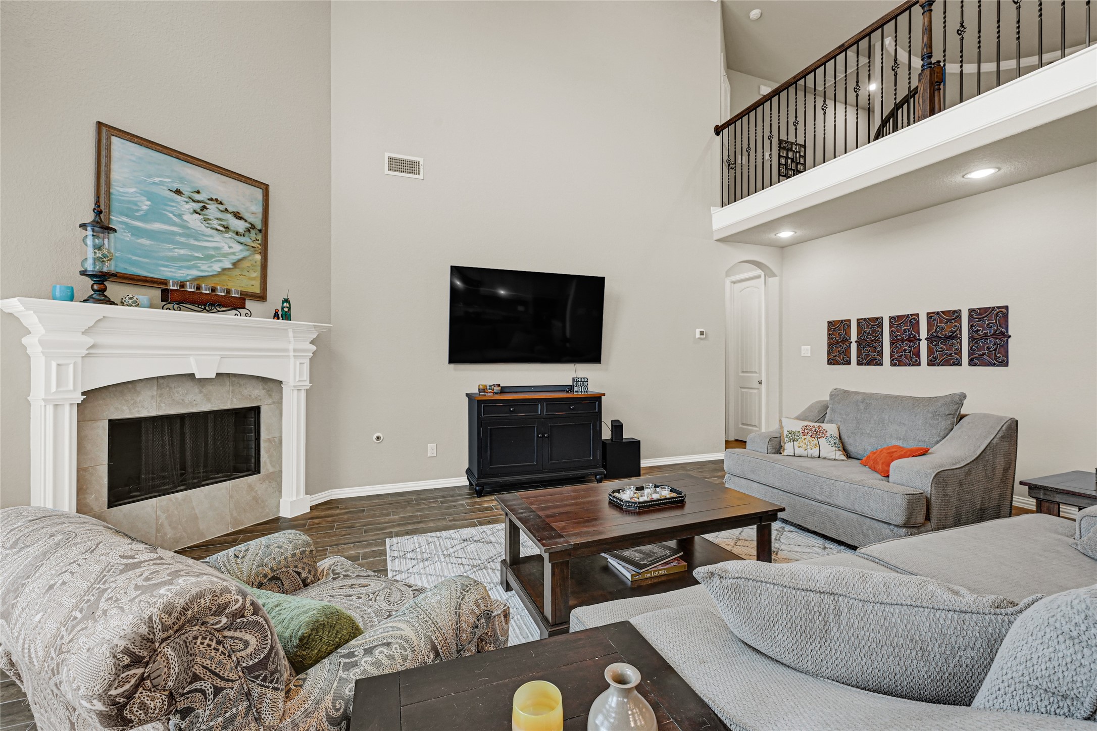 10319 Silver Shield Way Tomball, TX 77375 - Photo 15 of 46 a living room with furniture a flat screen tv and a fireplace