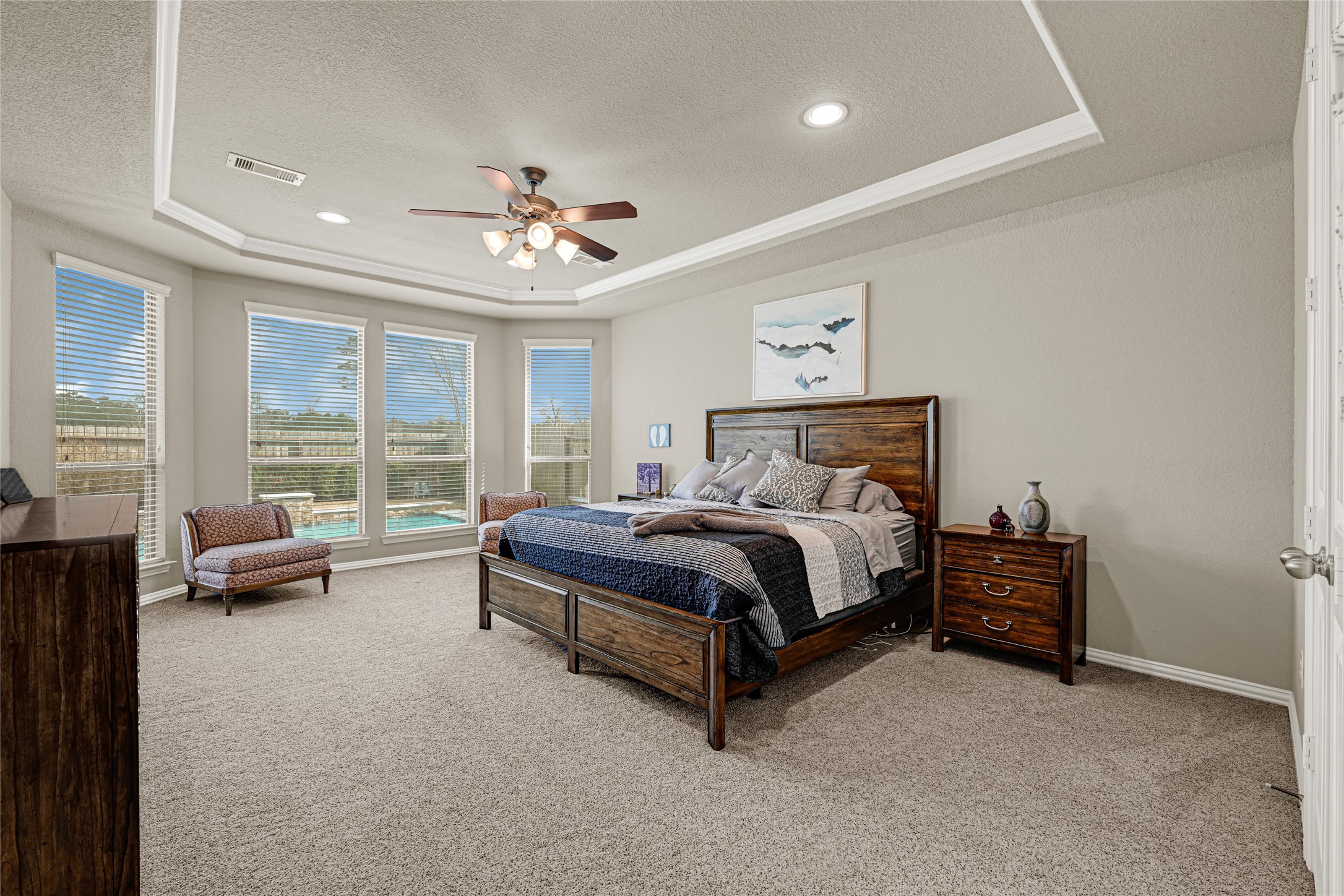 10319 Silver Shield Way Tomball, TX 77375 - Photo 18 of 46 a spacious bedroom with a bed and a couch