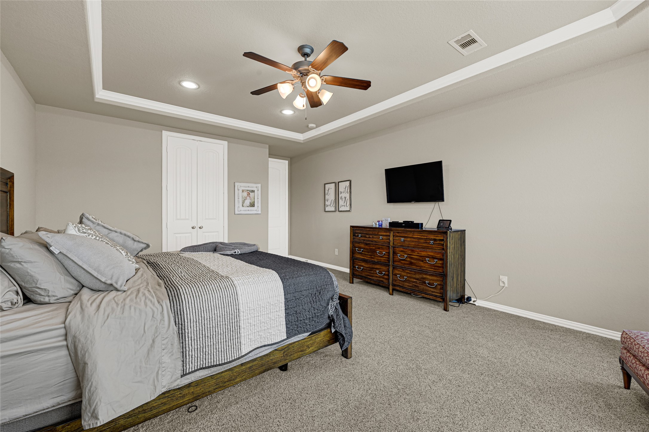 10319 Silver Shield Way Tomball, TX 77375 - Photo 19 of 46 a spacious bedroom with a bed and a flat screen tv