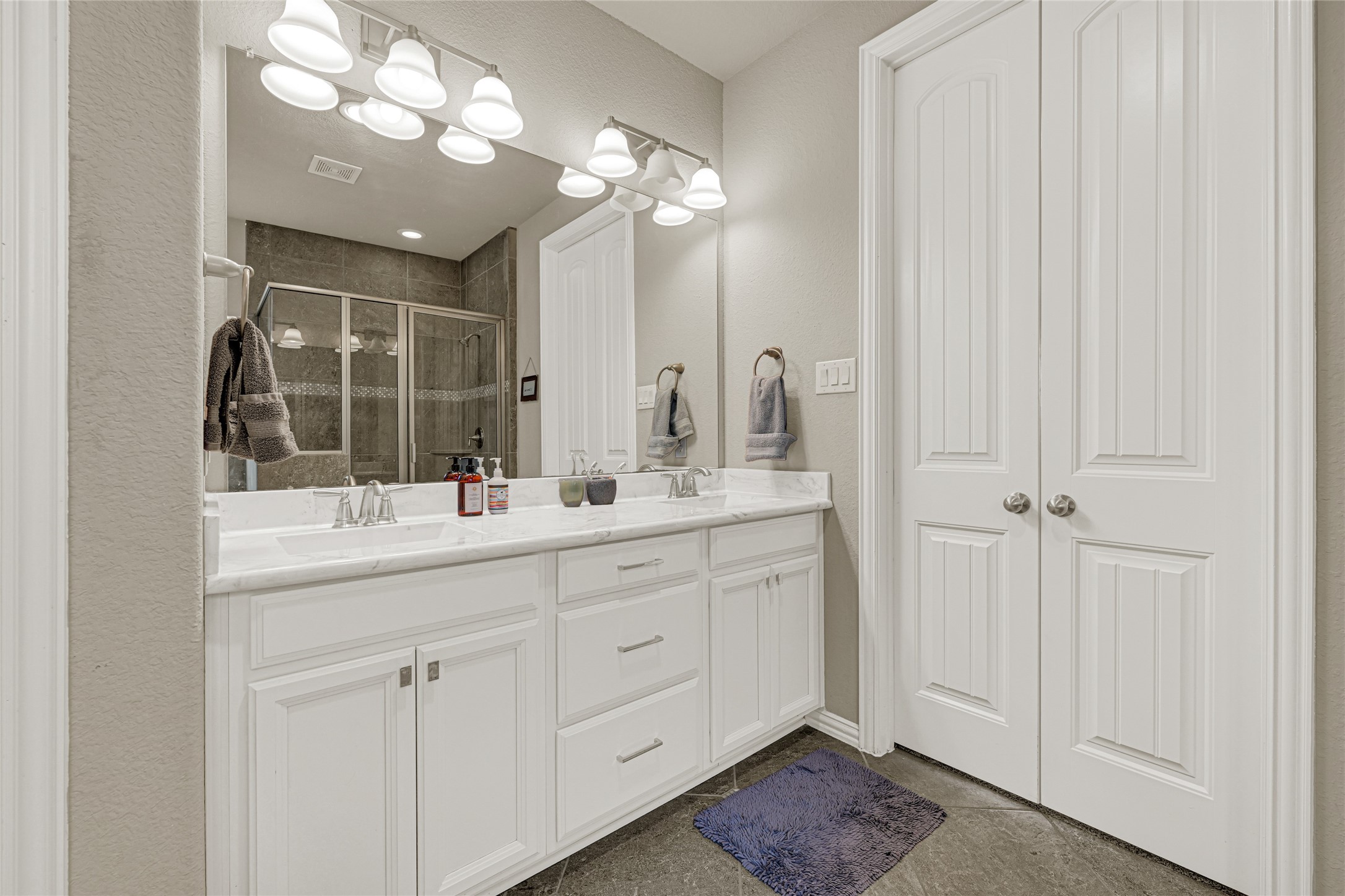 10319 Silver Shield Way Tomball, TX 77375 - Photo 20 of 46 a bathroom with a double vanity sink and a mirror