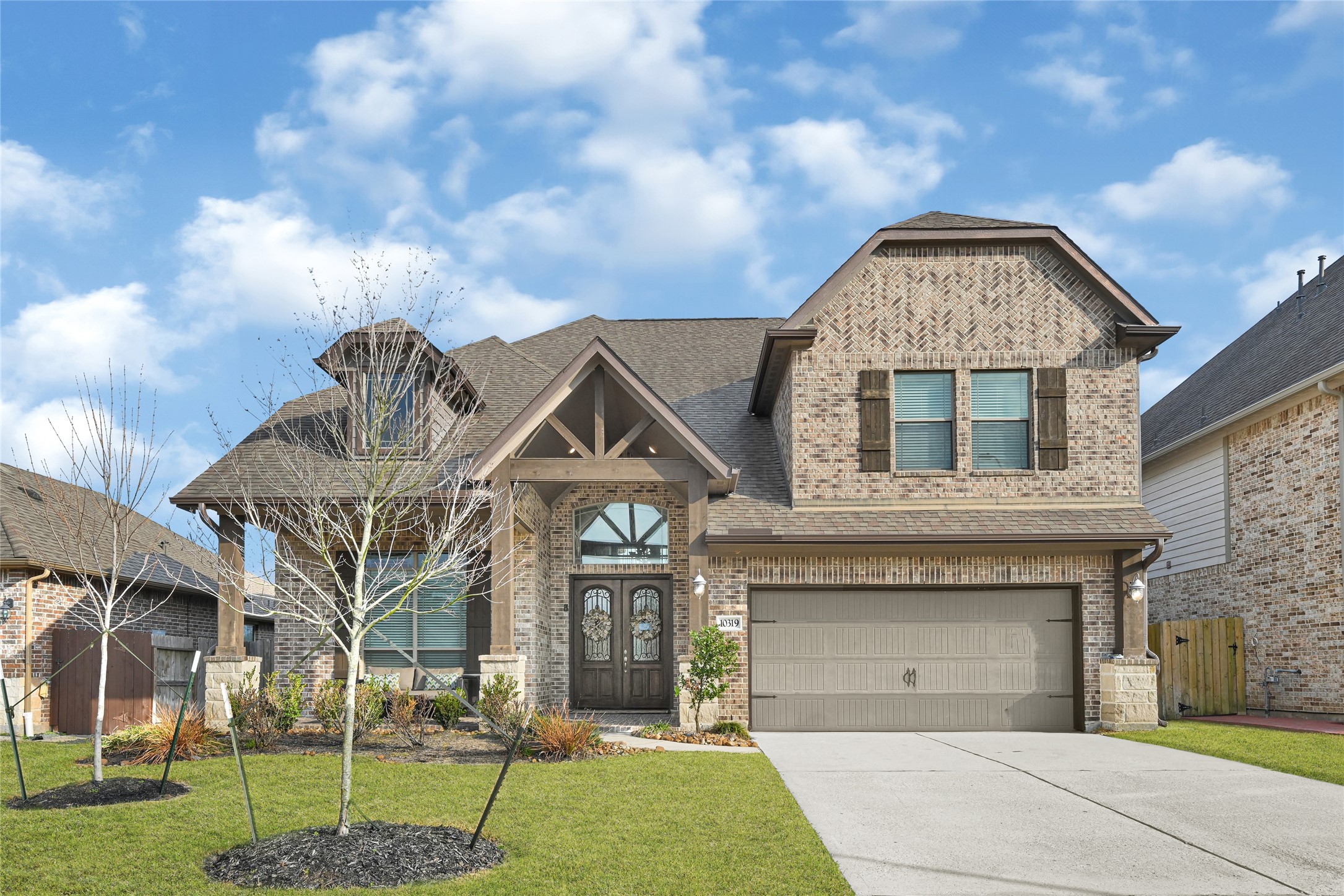 10319 Silver Shield Way Tomball, TX 77375 - Photo 2 of 46 a front view of a house with a garden