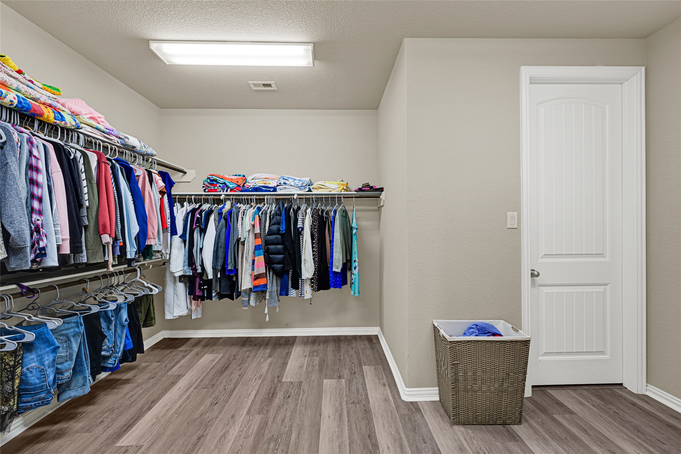 10319 Silver Shield Way Tomball, TX 77375 - Photo 22 of 46 a view of walk in closet with clothes