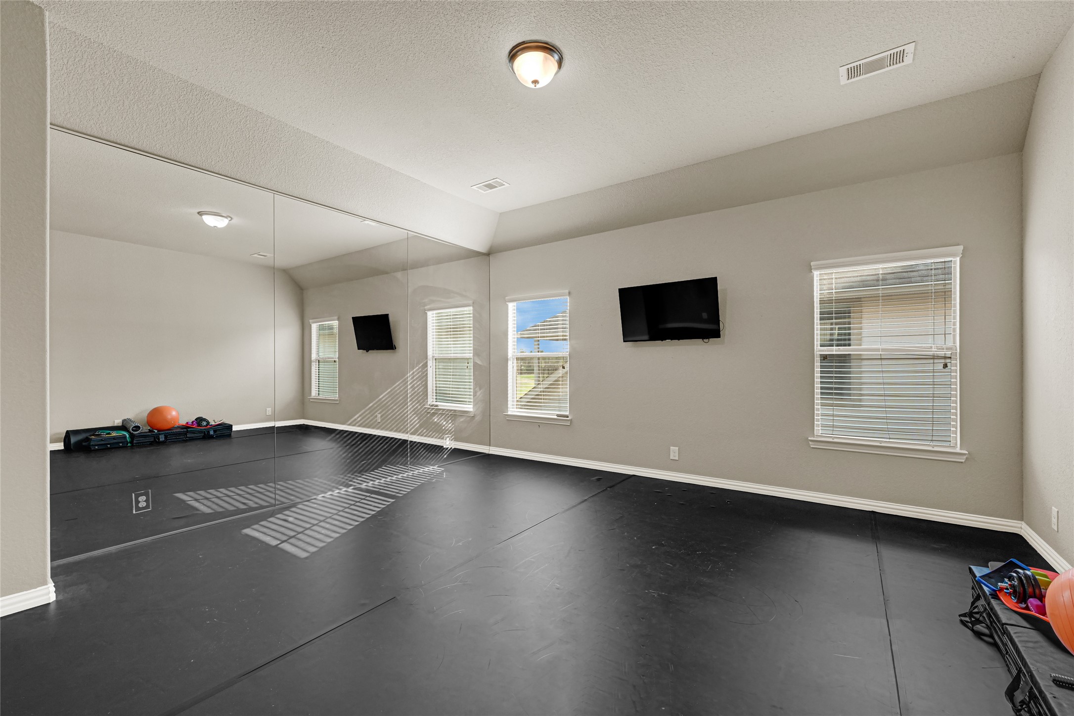 10319 Silver Shield Way Tomball, TX 77375 - Photo 29 of 46 an empty room with wooden floor and windows