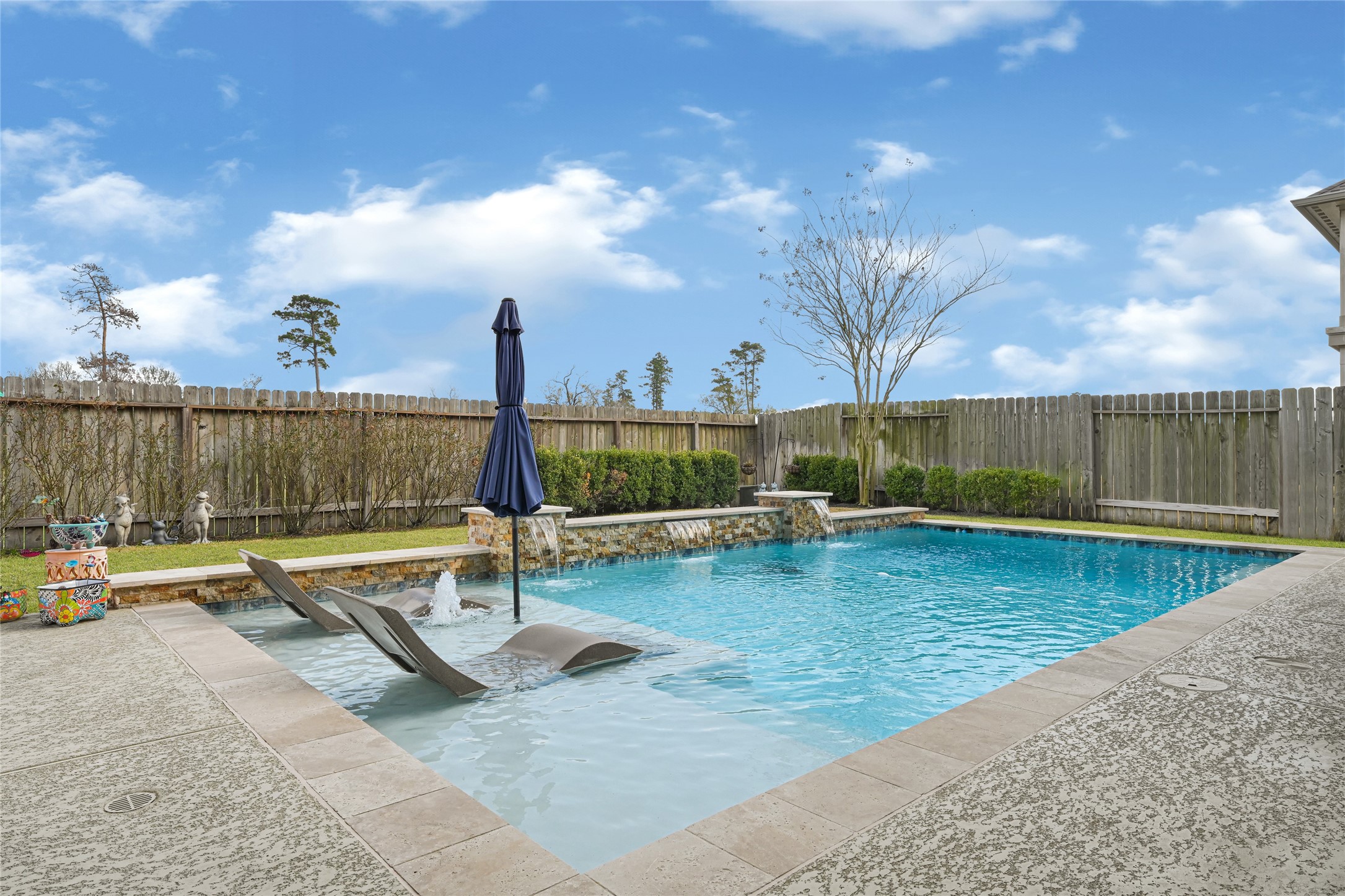 10319 Silver Shield Way Tomball, TX 77375 - Photo 40 of 46 a view of a swimming pool with a lounge chairs