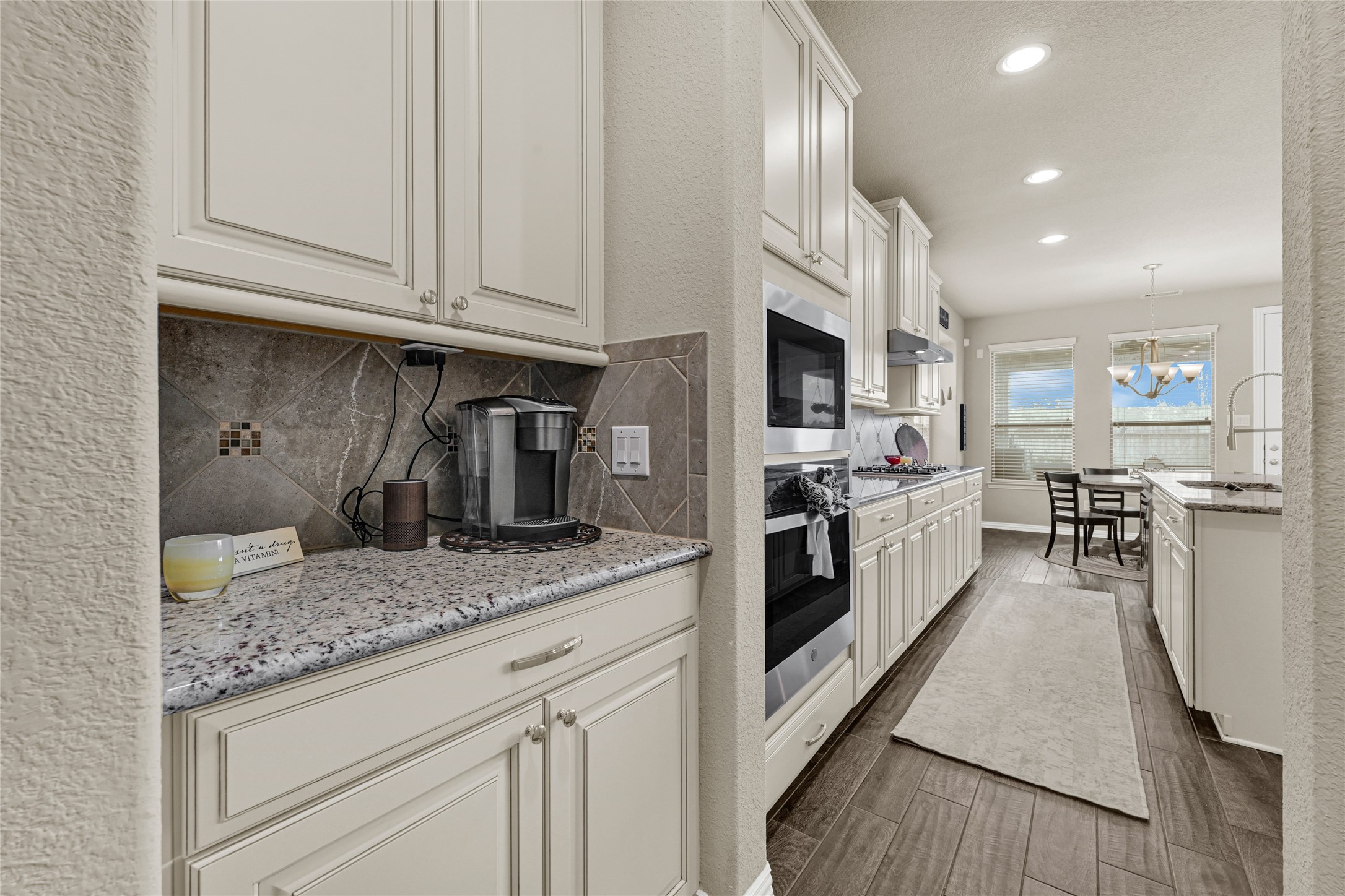 10319 Silver Shield Way Tomball, TX 77375 - Photo 10 of 46 a kitchen with stainless steel appliances granite countertop a stove a sink and a refrigerator