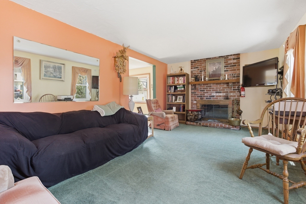 19 Mockingbird Lane Maynard, MA 01754 - Photo 2 of 34 a living room with furniture and a flat screen tv