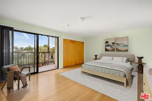 a spacious bedroom with a large bed and a large window