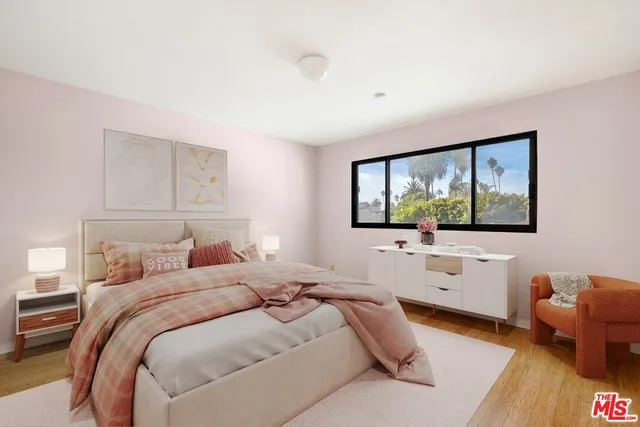 a bedroom with a bed and a flat screen tv