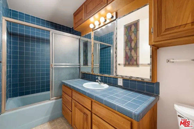 a bathroom with a sink a bathtub and a shower