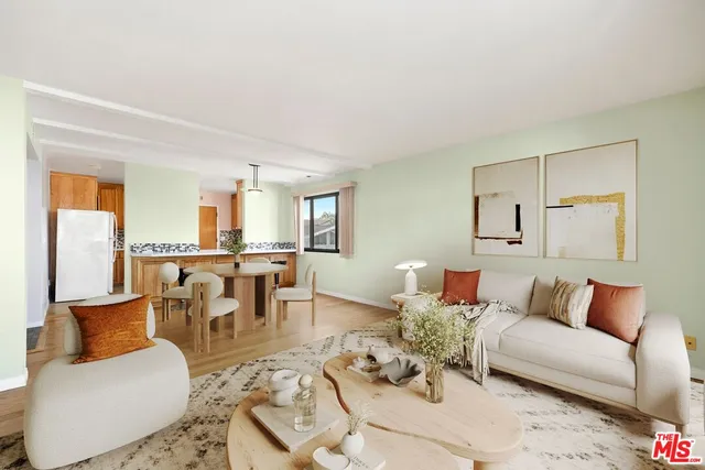 a living room with furniture kitchen view and a dining table
