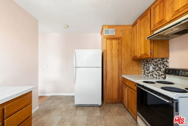a kitchen with a stove and a refrigerator