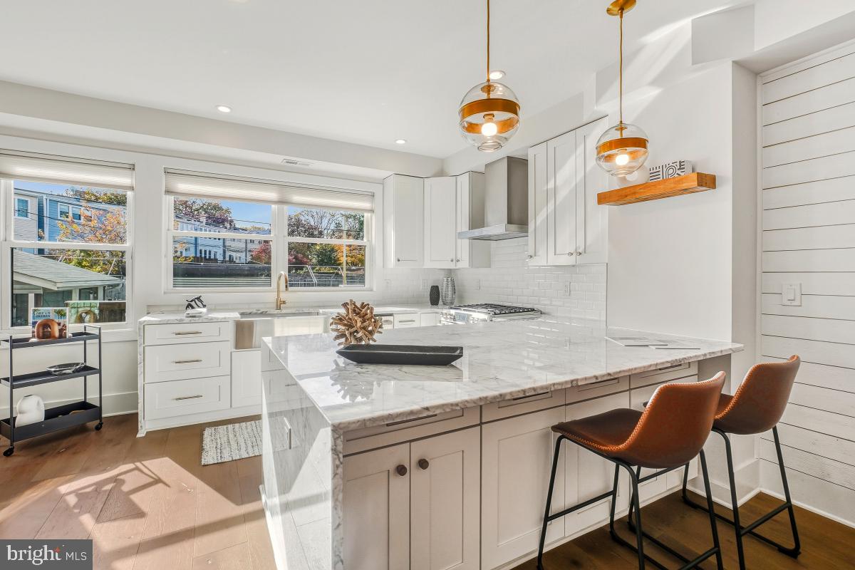 714 Decatur Street Northwest Washington, DC 20011 - Photo 14 of 40 a kitchen with stainless steel appliances granite countertop a sink and cabinets