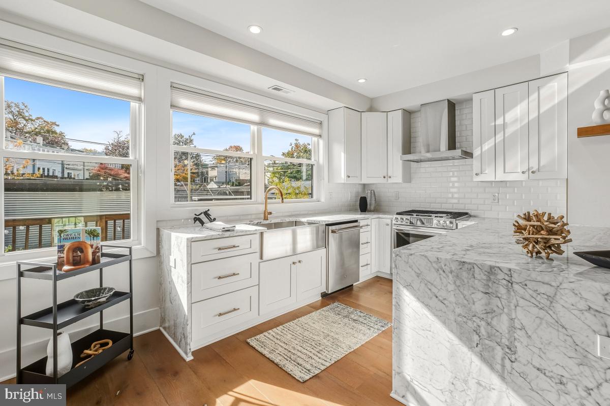 714 Decatur Street Northwest Washington, DC 20011 - Photo 16 of 40 a kitchen with a stove a sink and a refrigerator