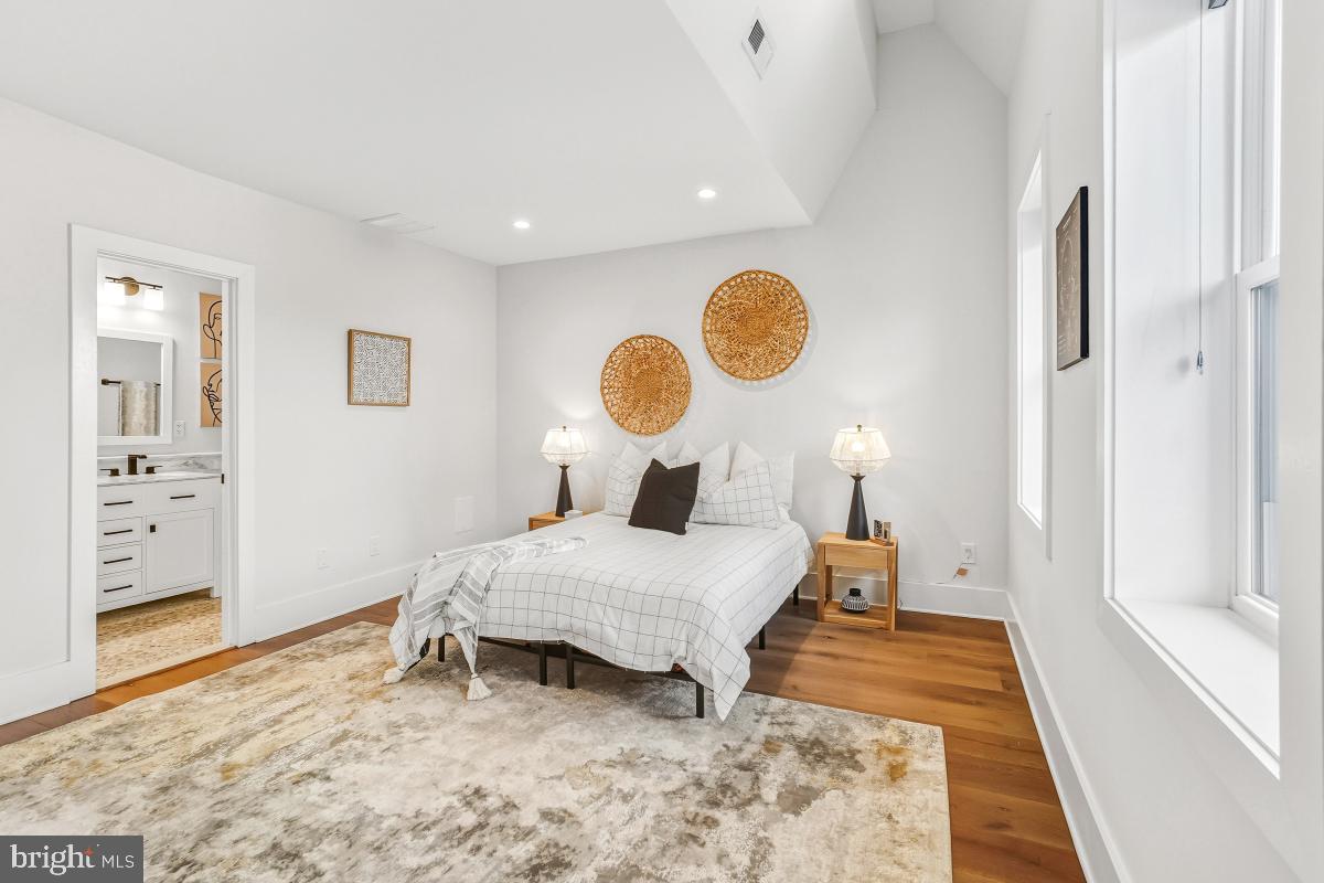 714 Decatur Street Northwest Washington, DC 20011 - Photo 19 of 40 a bedroom with a bed and wooden floor