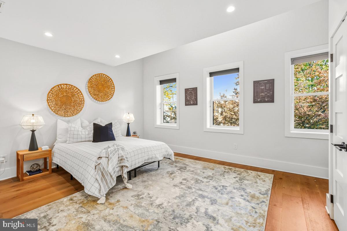714 Decatur Street Northwest Washington, DC 20011 - Photo 20 of 40 a bedroom with a bed mirror and window