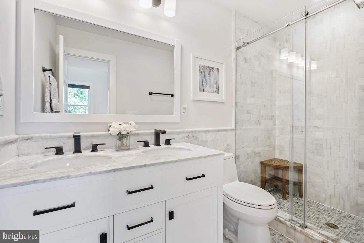 714 Decatur Street Northwest Washington, DC 20011 - Photo 21 of 40 a bathroom with a sink toilet vanity and shower