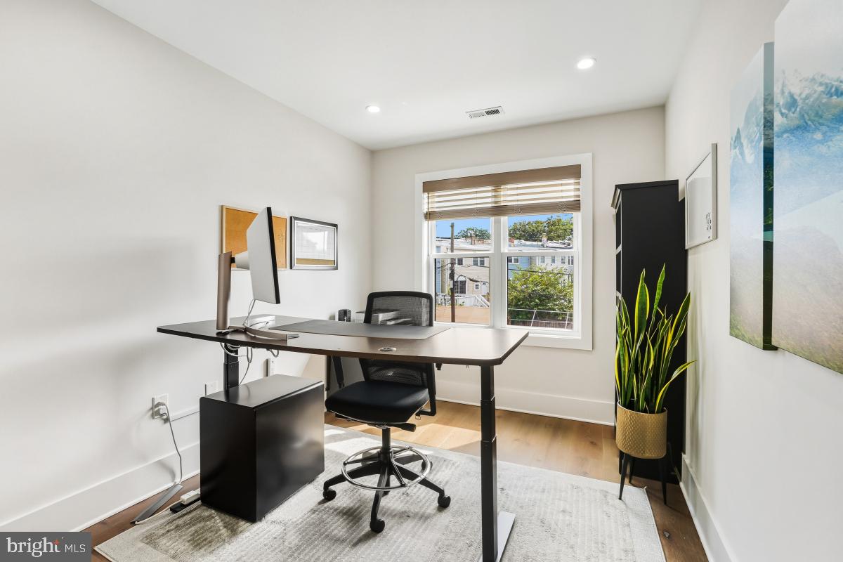714 Decatur Street Northwest Washington, DC 20011 - Photo 24 of 40 a view of a workspace with furniture and a window