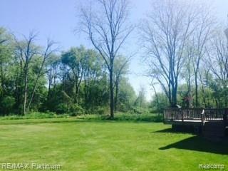 7680 Sharpe Road Fowlerville, MI 48836 - Photo 4 of 14 Large wood deck over looks your quiet back yard surrounded by adult trees giving you peace and privacy