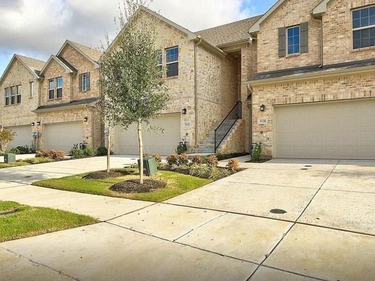 View of front of house featuring a garage, brick siding, and concrete driveway