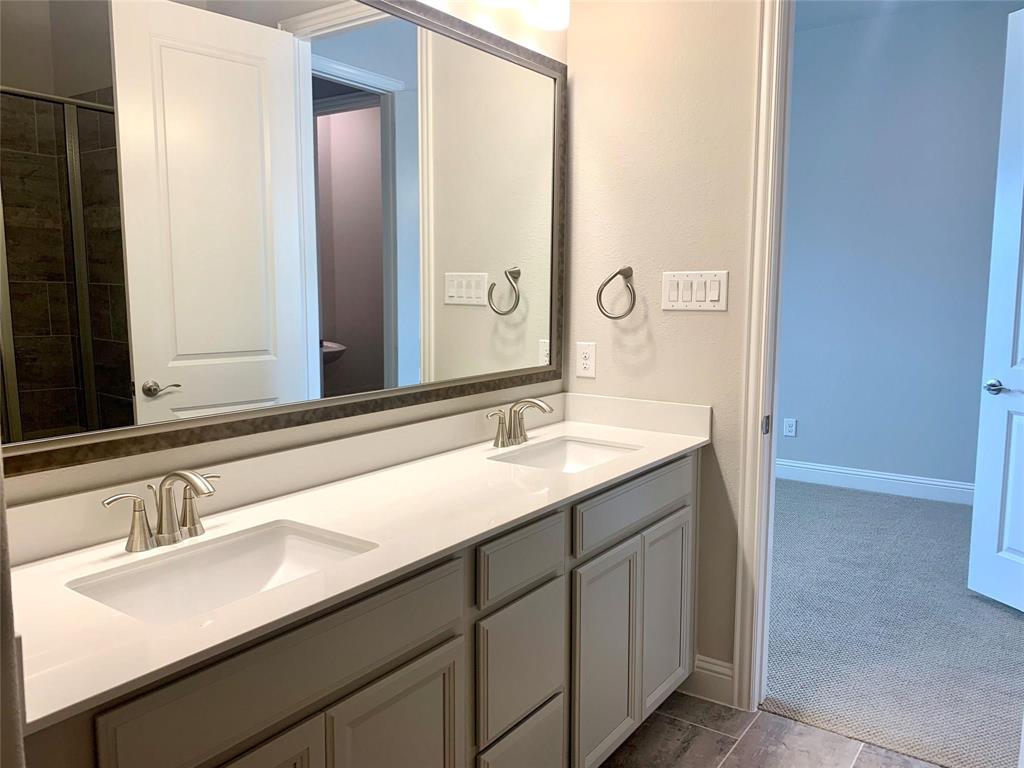 5537 Yellowstone Road The Colony, TX 75056 - Photo 10 of 25 Bathroom featuring double vanity and dark colored carpet