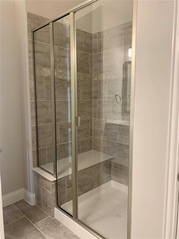 5537 Yellowstone Road The Colony, TX 75056 - Photo 11 of 25 Full bath featuring a stall shower and tile patterned flooring