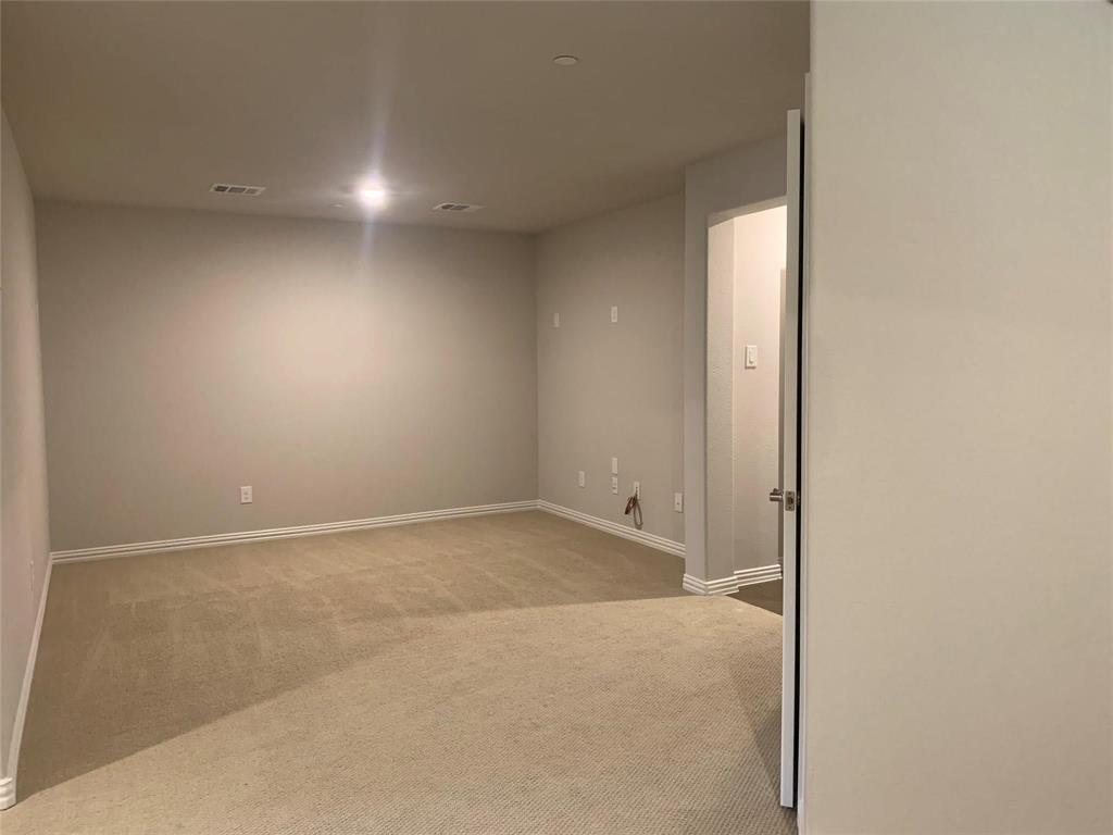 5537 Yellowstone Road The Colony, TX 75056 - Photo 15 of 25 Basement featuring light carpet and baseboards