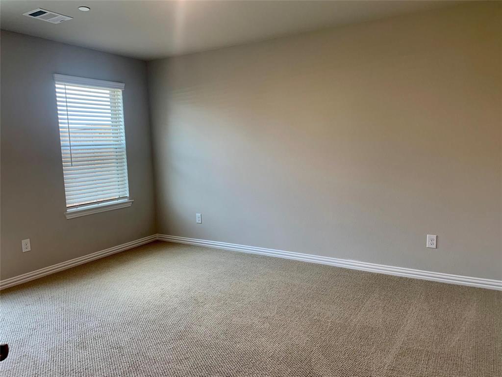 5537 Yellowstone Road The Colony, TX 75056 - Photo 17 of 25 Carpeted spare room with baseboards
