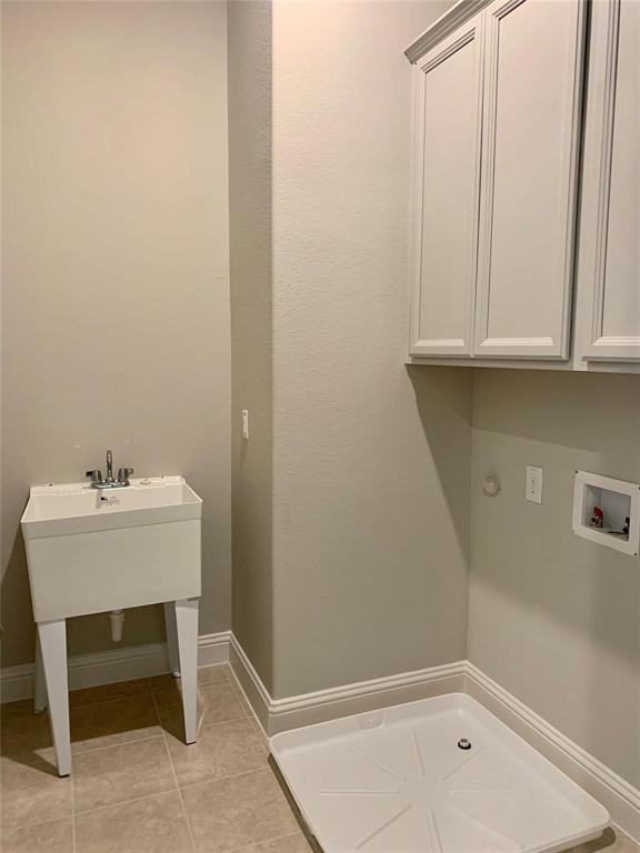 5537 Yellowstone Road The Colony, TX 75056 - Photo 21 of 25 Laundry area with light tile patterned floors and hookup for a washing machine