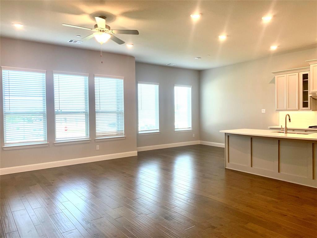 5537 Yellowstone Road The Colony, TX 75056 - Photo 4 of 25 Unfurnished living room featuring dark wood-type flooring, a ceiling fan, and recessed lighting