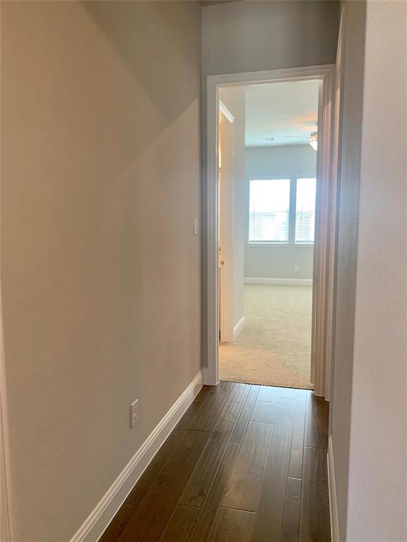 5537 Yellowstone Road The Colony, TX 75056 - Photo 8 of 25 Hall featuring baseboards and dark wood-style floors