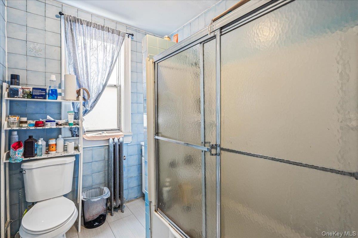 34-49 110th Street Queens, NY 11368 - Photo 13 of 21 a bathroom with a toilet and a shower