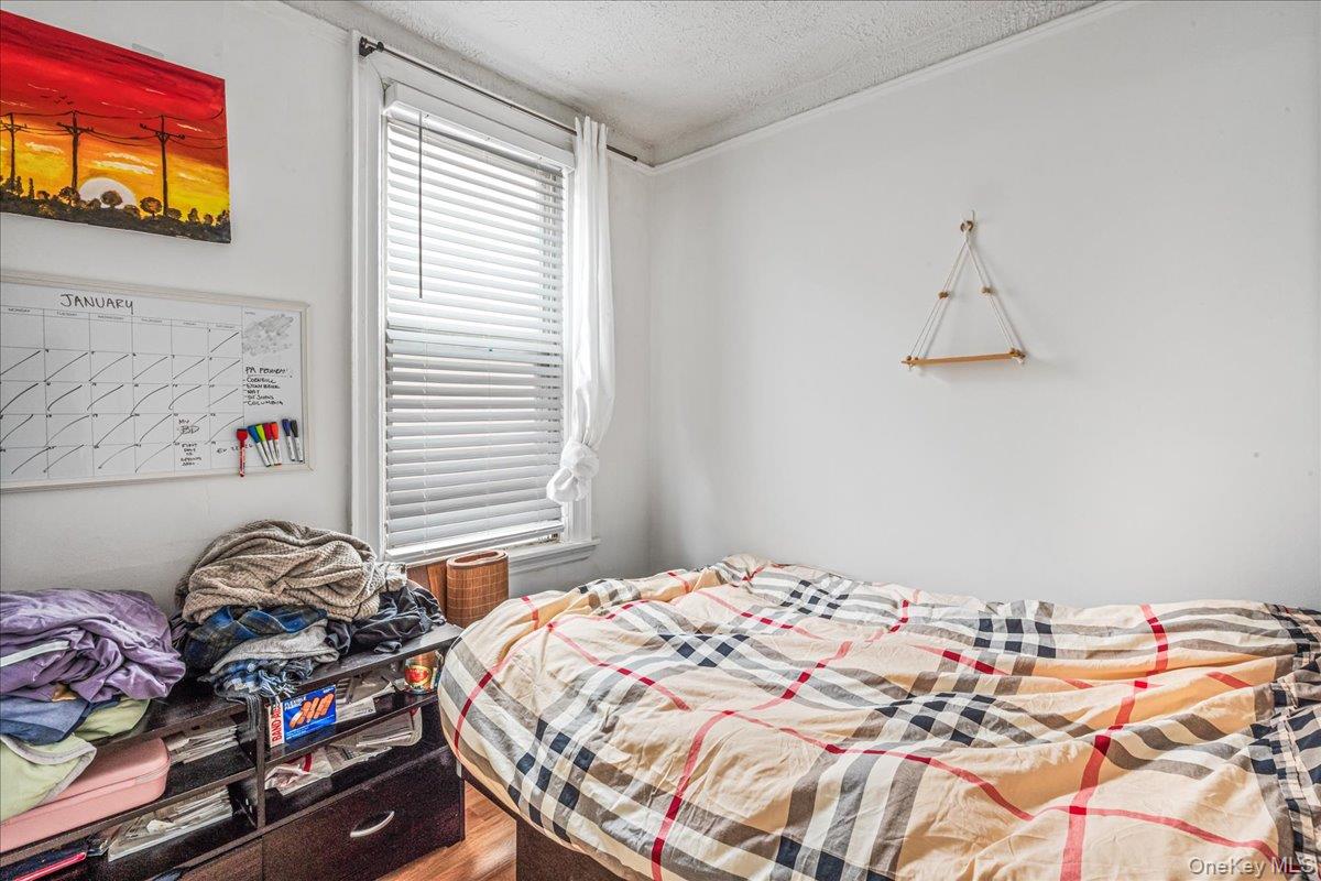 34-49 110th Street Queens, NY 11368 - Photo 15 of 21 a bedroom with a bed and a window