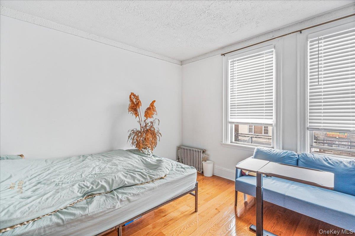 34-49 110th Street Queens, NY 11368 - Photo 16 of 21 a bedroom with a bed and a window