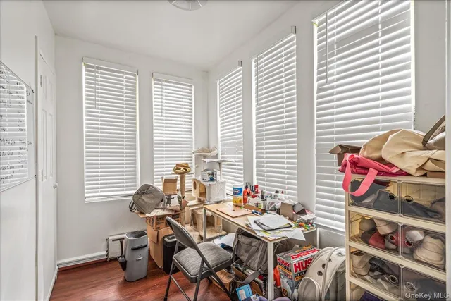 a view of a workspace with furniture and a window