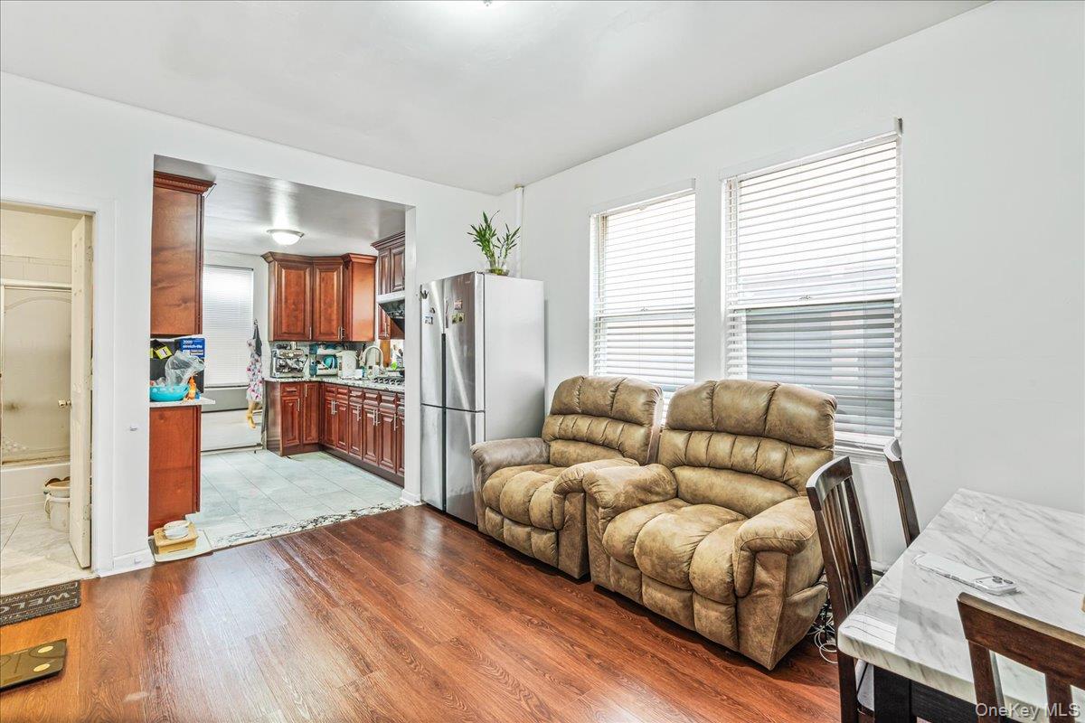 34-49 110th Street Queens, NY 11368 - Photo 5 of 21 a living room with furniture and a kitchen