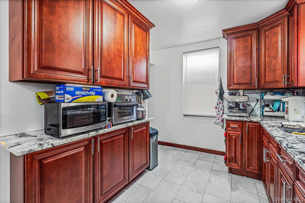 34-49 110th Street Queens, NY 11368 - Photo 9 of 21 a kitchen with stainless steel appliances granite countertop a stove a sink dishwasher and a refrigerator