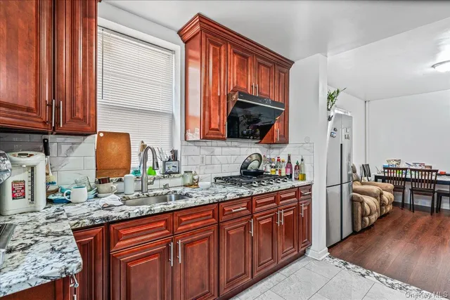 a kitchen with stainless steel appliances granite countertop a sink stove and refrigerator
