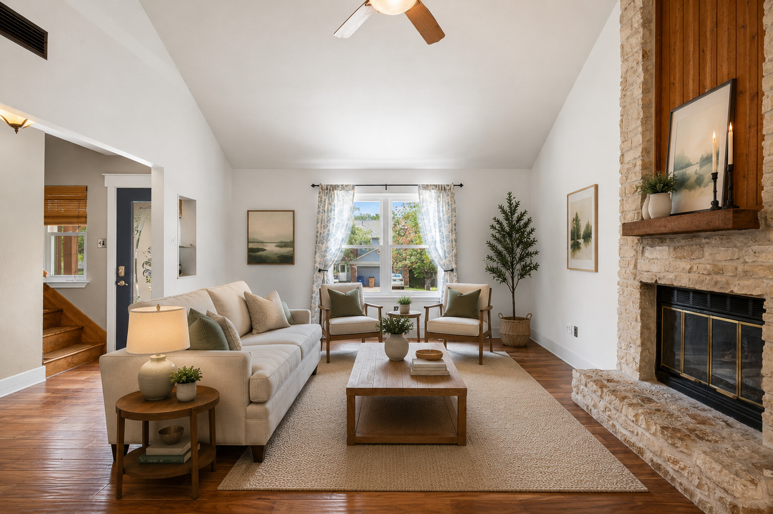 11905 Rickem Cove Austin, TX 78758 - Photo 1 of 1 A well-lit living area features a charming stone fireplace and rich hardwood flooring.